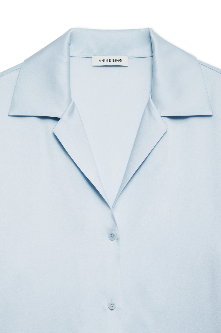 Detailaufnahme des spitzen Kragens und der Knopfleiste der Anine Bing Bethany Bluse in Pale Blue.